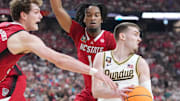 North Carolina State Wolfpack forward Ben Middlebrooks and guard Jayden Taylor defend Purdue Boilermakers guard Braden Smith