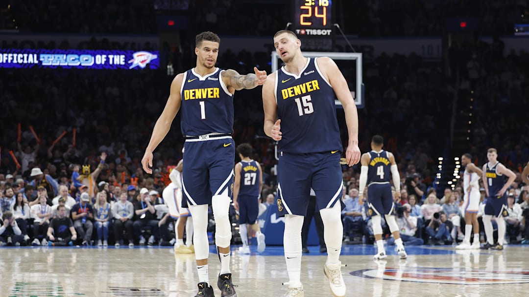 Mar 10, 2025; Oklahoma City, Oklahoma, USA; Denver Nuggets forward Michael Porter Jr. (1) and center Nikola Jokic (15) talk during a time out against the Oklahoma City Thunder during the second half at Paycom Center. Mandatory Credit: Alonzo Adams-Imagn Images