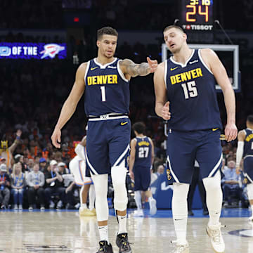 Mar 10, 2025; Oklahoma City, Oklahoma, USA; Denver Nuggets forward Michael Porter Jr. (1) and center Nikola Jokic (15) talk during a time out against the Oklahoma City Thunder during the second half at Paycom Center. Mandatory Credit: Alonzo Adams-Imagn Images