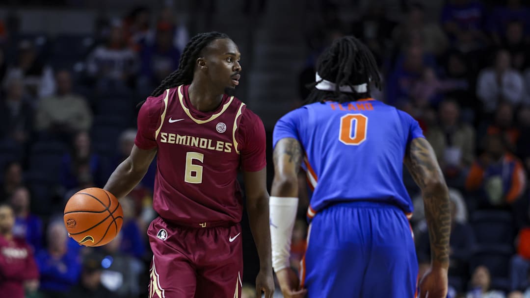 Nov 11, 2025; Gainesville, Florida, USA; Florida State Seminoles guard Robert McCray V (6) dribbles the ball against Florida Gators guard Boogie Fland (0) during the first half at Exactech Arena at the Stephen C. O'Connell Center. Mandatory Credit: Morgan Tencza-Imagn Images