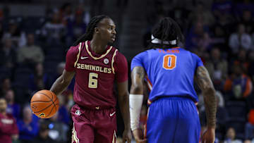 Nov 11, 2025; Gainesville, Florida, USA; Florida State Seminoles guard Robert McCray V (6) dribbles the ball against Florida Gators guard Boogie Fland (0) during the first half at Exactech Arena at the Stephen C. O'Connell Center. Mandatory Credit: Morgan Tencza-Imagn Images