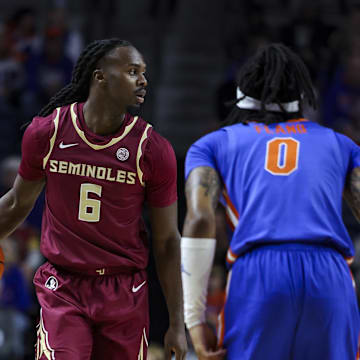 Nov 11, 2025; Gainesville, Florida, USA; Florida State Seminoles guard Robert McCray V (6) dribbles the ball against Florida Gators guard Boogie Fland (0) during the first half at Exactech Arena at the Stephen C. O'Connell Center. Mandatory Credit: Morgan Tencza-Imagn Images