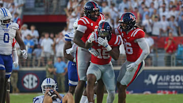 Aug 30, 2025; Oxford, Mississippi, USA; Mississippi Rebels defensive end Kam Franklin (5) and linebacker Tahj Chambers (26) react with defensive end Da'Shawn Womack (15) after sacking Georgia State Panthers quarterback Christian Veilleux (11) during the first quarter at Vaught-Hemingway Stadium. Mandatory Credit: Petre Thomas-Imagn Images