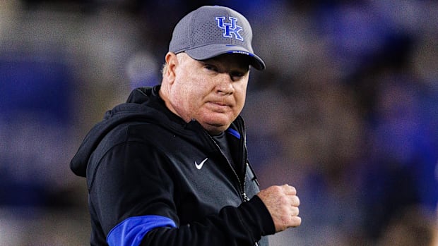 Kentucky head coach Mark Stoops runs onto the field before the game against Auburn.