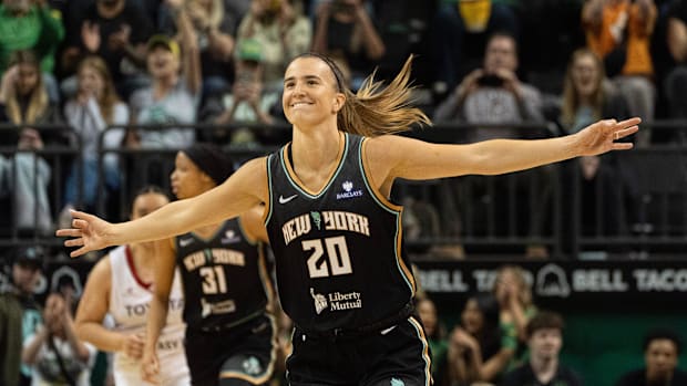 Sabrina Ionescu celebrates a three