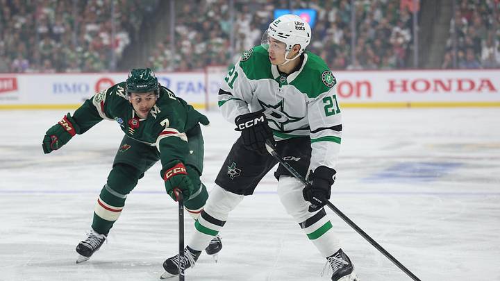 Apr 22, 2026; Saint Paul, Minnesota, USA; Dallas Stars left wing Jason Robertson (21) skates with the puck as Minnesota Wild defenseman Brock Faber (7) defends during the first period in game three of the first round of the 2026 Stanley Cup Playoffs at Grand Casino Arena. Mandatory Credit: Matt Krohn-Imagn Images