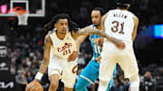 Apr 14, 2024; Cleveland, Ohio, USA; Cleveland Cavaliers forward Emoni Bates (21) dribbles around Charlotte Hornets guard Amari Bailey (10) in the second 
quarter at Rocket Mortgage FieldHouse. Mandatory Credit: David Richard-Imagn Images