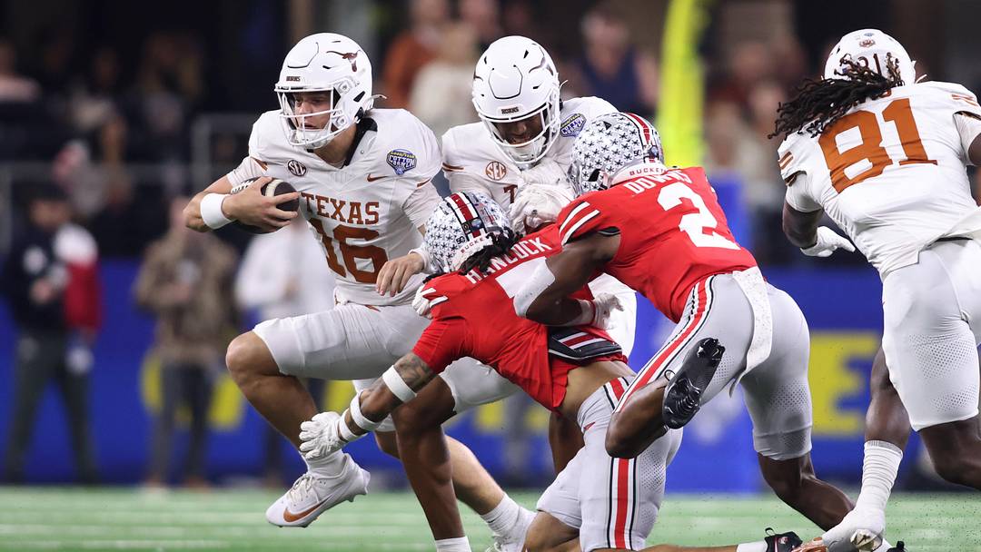 Jan 10, 2025; Arlington, Texas, USA; Texas Longhorns quarterback Arch Manning (16) runs against Ohio State Buckeyes cornerback Jordan Hancock (7) and safety Caleb Downs (2) during the second quarter of the College Football Playoff semifinal in the Cotton Bowl at AT&T Stadium. Mandatory Credit: Tim Heitman-Imagn Images Jan 10, 2025; Arlington, Texas, USA; Texas Longhorns quarterback Arch Manning (16) runs against Ohio State Buckeyes cornerback Jordan Hancock (7) and safety Caleb Downs (2) during the second quarter of the College Football Playoff semifinal in the Cotton Bowl at AT&T Stadium. Mandatory Credit: Tim Heitman-Imagn Images