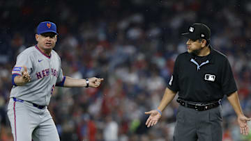 Apr 25, 2025; Washington, District of Columbia, USA; New York Mets manager Carlos Mendoza (64) argues with first base umpire Alfonso Marquez (72) against the Washington Nationals during the fourth inning at Nationals Park. Mandatory Credit: Geoff Burke-Imagn Images