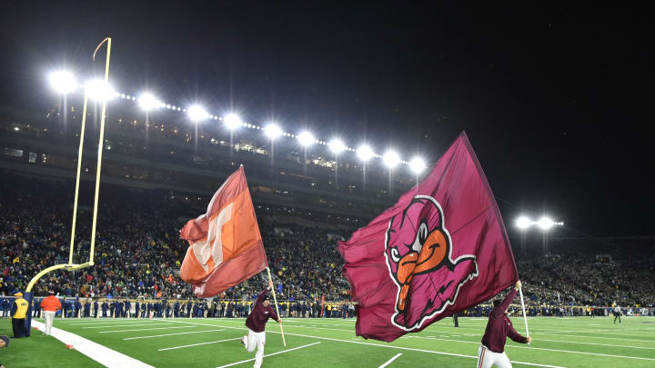 Nov 19, 2016; South Bend, IN, USA; Virginia Tech Hokies cheerleaders carry the Virginia Tech flags following a Hokies score in the fourth quarter against the Notre Dame Fighting Irish at Notre Dame Stadium. Virginia Tech won 34-31. Mandatory Credit: Matt Cashore-USA TODAY Sports