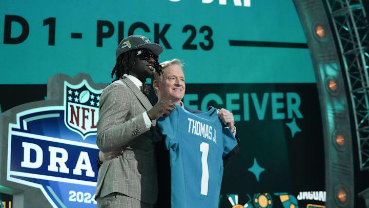 Apr 25, 2024; Detroit, MI, USA; LSU Tigers wide receiver Brian Thomas Jr. poses with NFL commissioner Roger Goodell after being selected by the Jacksonville Jaguars as the No. 23 pick during the first round of the 2024 NFL Draft at Campus Martius Park and Hart Plaza. Mandatory Credit: Kirby Lee-Imagn Images