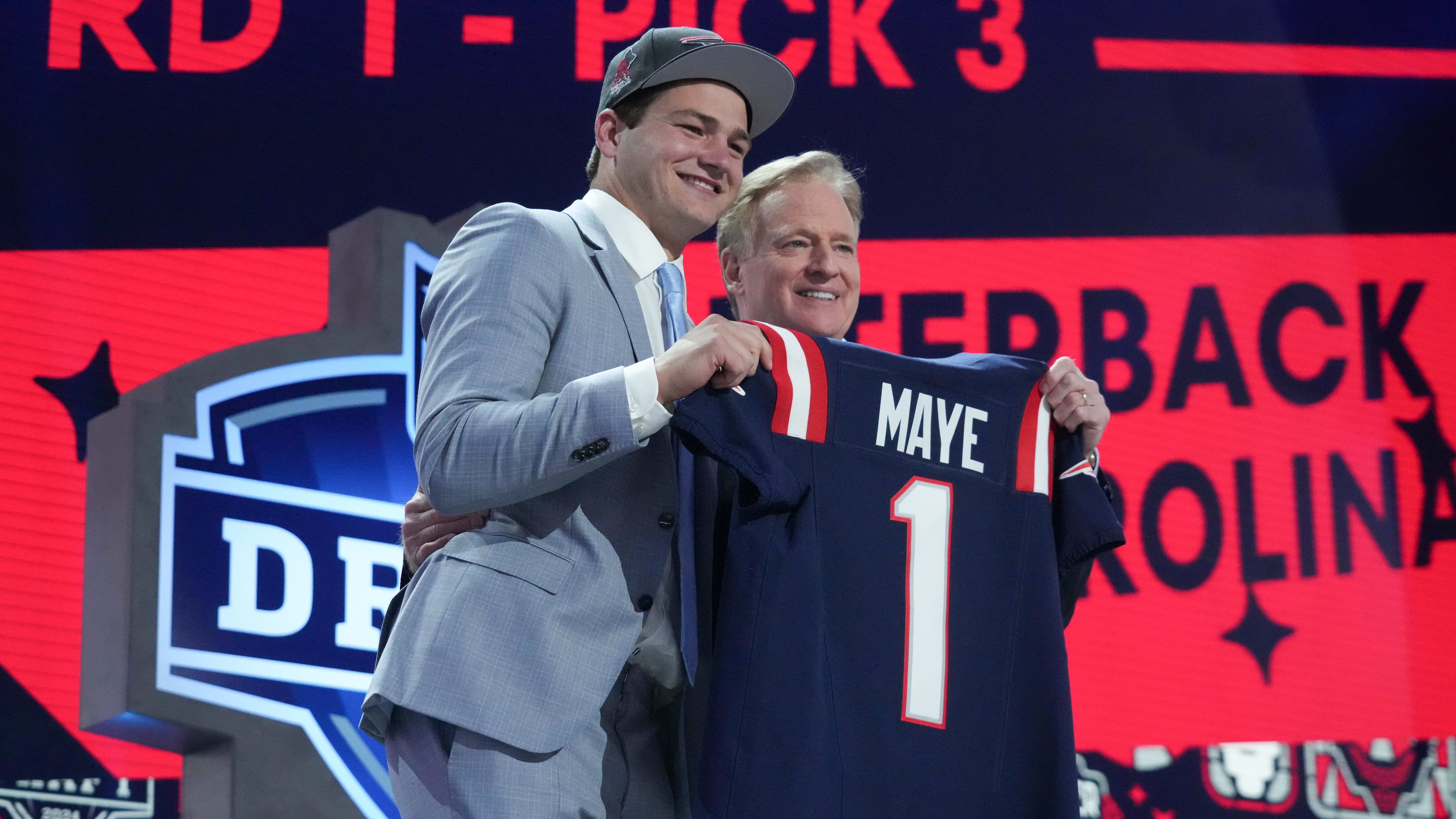 Drake Maye poses with NFL Commissioner Roger Goodell at the 2024 NFL Draft.