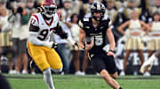 Purdue Boilermakers quarterback Ryan Browne (15) is chased by USC Trojans defensive tackle Jide Abasiri (97) 