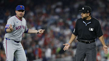 Apr 25, 2025; Washington, District of Columbia, USA; New York Mets manager Carlos Mendoza (64) argues with first base umpire Alfonso Marquez (72) against the Washington Nationals during the fourth inning at Nationals Park. 
