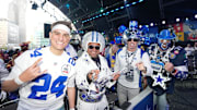Dallas Cowboys fans pose for a photograph during the 2024 NFL Draft at Campus Martius Park and Hart Plaza. 
