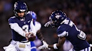 Nov 1, 2024; East Hartford, Connecticut, USA; Connecticut Huskies quarterback Nick Evers (3) hands off the ball to running back Mel Brown (7) against the Georgia State Panthers in the first quarter at Rentschler Field at Pratt & Whitney Stadium. Mandatory Credit: David Butler II-Imagn Images