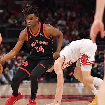 Feb 28, 2025; Chicago, Illinois, USA; Toronto Raptors guard Ja'Kobe Walter (14) controls the ball during the first half against the Chicago Bulls at the United Center. Mandatory Credit: Patrick Gorski-Imagn Images