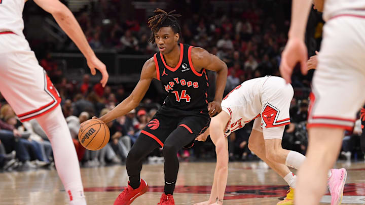 Feb 28, 2025; Chicago, Illinois, USA; Toronto Raptors guard Ja'Kobe Walter (14) controls the ball during the first half against the Chicago Bulls at the United Center. Mandatory Credit: Patrick Gorski-Imagn Images