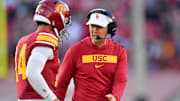 Nov 16, 2024; Los Angeles, California, USA; Southern California Trojans head coach Lincoln Riley greets quarterback Jayden Maiava (14) after scoring a touchdown against the Nebraska Cornhuskers during the second half at the Los Angeles Memorial Coliseum. Mandatory Credit: Gary A. Vasquez-Imagn Images
