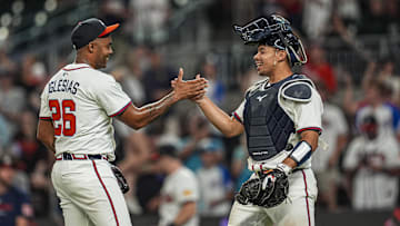 Aug 7, 2025; Cumberland, Georgia, USA; Atlanta Braves relief pitcher Raisel Iglesias (26) reacts with catcher Drake Baldwin (30) after the Braves defeated the Miami Marlins at Truist Park. Mandatory Credit: Dale Zanine-Imagn Images