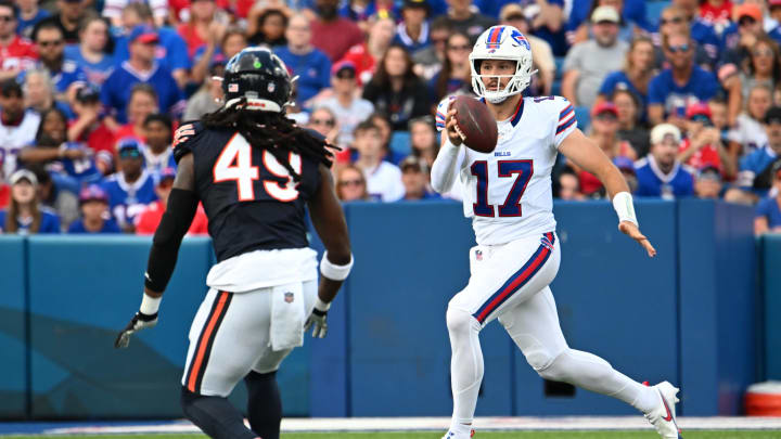 Aug 10, 2024; Orchard Park, New York, USA; Buffalo Bills quarterback Josh Allen (17) carries the ball defended by Chicago Bears linebacker Tremaine Edmunds (49) in the first quarter of a pre-season game at Highmark Stadium. Mandatory Credit: Mark Konezny-USA TODAY Sports