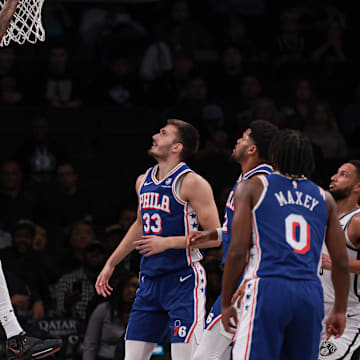 Oct 16, 2023; Brooklyn, New York, USA; Brooklyn Nets center Nic Claxton (33) dunks the ball during the first quarter in front of Philadelphia 76ers guard Kelly Oubre Jr. (9) and forward Filip Petrusev (33) at Barclays Center. Mandatory Credit: Vincent Carchietta-Imagn Images