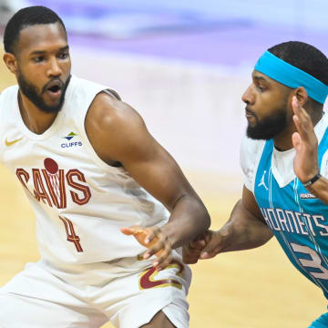 Apr 14, 2024; Cleveland, Ohio, USA; Cleveland Cavaliers forward Evan Mobley (4) dribbles against Charlotte Hornets center Marques Bolden (3) in the first quarter at Rocket Mortgage FieldHouse. Mandatory Credit: David Richard-USA TODAY Sports