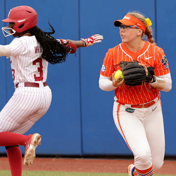 Alabama's Kristen White (3) celebrates a base hit next to Florida's Mia Williams (11) in the third inning of the Women's College World Series game between the Alabama and Florida at Devon Park in Oklahoma City, Sunday, June, 2, 2024.