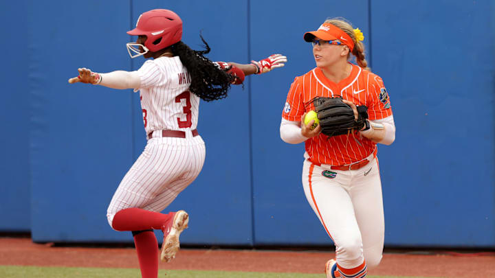 Alabama's Kristen White (3) celebrates a base hit next to Florida's Mia Williams (11) in the third inning of the Women's College World Series game between the Alabama and Florida at Devon Park in Oklahoma City, Sunday, June, 2, 2024.