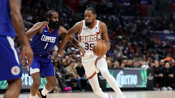 Jan 8, 2024; Los Angeles, California, USA;  Phoenix Suns forward Kevin Durant (35) dribbles the ball against Los Angeles Clippers guard James Harden (1) during the fourth quarter at Crypto.com Arena. Mandatory Credit: Kiyoshi Mio-Imagn Images