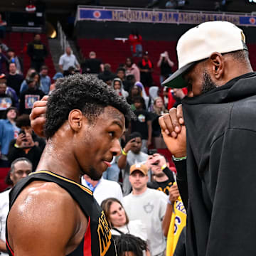 Mar 28, 2023; Houston, TX, USA; McDonald's All American West guard Bronny James (6) speaks with his father, LeBron James of the Los Angeles Lakers, after the game against the McDonald's All American East at Toyota Center. Mandatory Credit: Maria Lysaker-Imagn Images