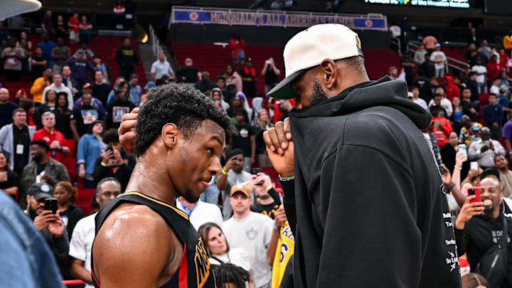 Mar 28, 2023; Houston, TX, USA; McDonald's All American West guard Bronny James (6) speaks with his father, LeBron James of the Los Angeles Lakers, after the game against the McDonald's All American East at Toyota Center. Mandatory Credit: Maria Lysaker-Imagn Images