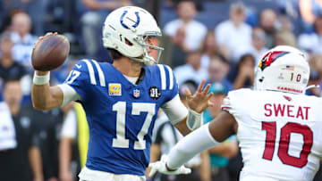 Indianapolis Colts quarterback Daniel Jones (17) passes the ball under pressure from Arizona Cardinals outside linebacker Josh Sweat (10) during the second quarter of the game at Lucas Oil Stadium.