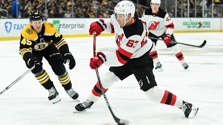 Apr 15, 2025; Boston, Massachusetts, USA;  New Jersey Devils left wing Jesper Bratt (63) shoots the puck while Boston Bruins left wing Cole Koepke (45) defends during the second period at TD Garden. Mandatory Credit: Bob DeChiara-Imagn Images