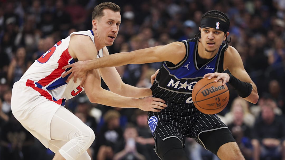 Apr 25, 2026; Orlando, Florida, USA; Orlando Magic guard Anthony Black (0) is guarded by Detroit Pistons forward Duncan Robinson (55) in the fourth quarter during game three of the first round of the 2026 NBA Playoffs at Kia Center. Mandatory Credit: Nathan Ray Seebeck-Imagn Images