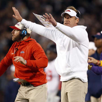 Nov 23, 2023; Starkville, Mississippi, USA; Mississippi Rebels head coach Lane Kiffin signals during the first half against the Mississippi State Bulldogs at Davis Wade Stadium at Scott Field. Mandatory Credit: Petre Thomas-USA TODAY Sports