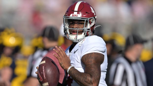 Crimson Tide quarterback Jalen Milroe warms up before a game against Michigan