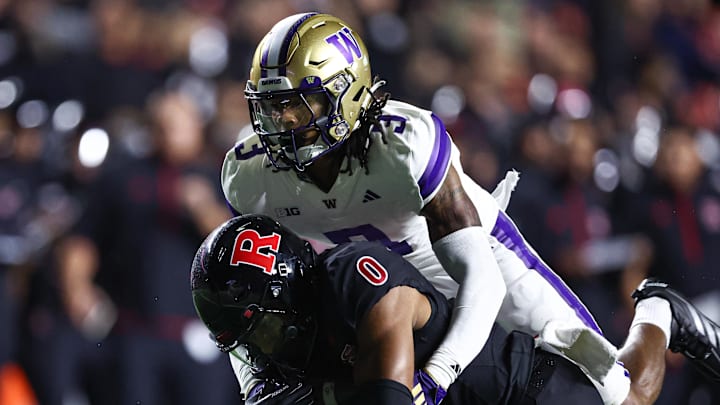 Sep 27, 2024; Piscataway, New Jersey, USA; Rutgers Scarlet Knights wide receiver Dymere Miller (0) is tackled by Washington Huskies cornerback Jordan Shaw (3) during the first half at SHI Stadium. Mandatory Credit: Vincent Carchietta-Imagn Images