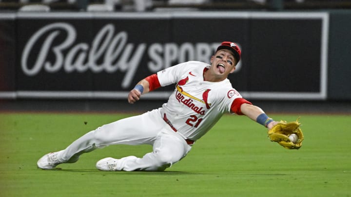 Aug 20, 2024; St. Louis, Missouri, USA;  St. Louis Cardinals right fielder Lars Nootbaar (21) dives and catches a fly ball against the Milwaukee Brewers during the seventh inning at Busch Stadium. Mandatory Credit: Jeff Curry-USA TODAY Sports