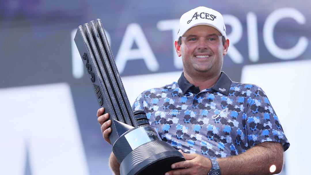 Patrick Reed poses with the winner's trophy following his victory at LIV Golf Dallas