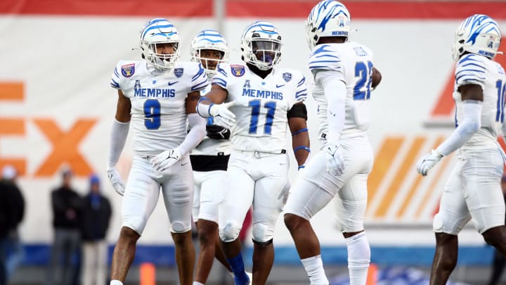 Dec 29, 2023; Memphis, TN, USA; Memphis Tigers linebacker Geoffrey Cantin-Arku (9) and Memphis Tigers linebacker Chandler Martin (11) react after a defensive stop during the first half against the Iowa State Cyclones at Simmons Bank Liberty Stadium. Mandatory Credit: Petre Thomas-USA TODAY Sports