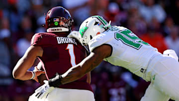 Sep 7, 2024; Blacksburg, Virginia, USA; Marshall Thundering Herd defensive lineman Mike Green (15) sacks Virginia Tech Hokies quarterback Kyron Drones (1) during the first quarter at Lane Stadium. Mandatory Credit: Peter Casey-Imagn Images