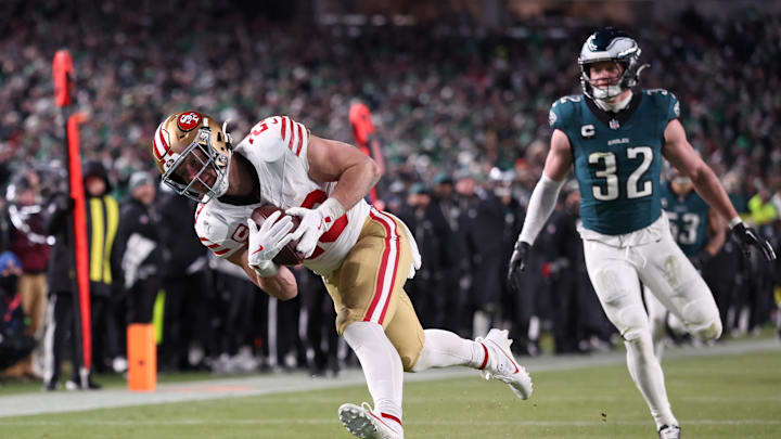 Jan 11, 2026; Philadelphia, PA, USA; San Francisco 49ers running back Christian McCaffrey (23) makes a catch for a touchdown defended by Philadelphia Eagles safety Reed Blankenship (32) during the fourth quarter in an NFC Wild Card Round game at Lincoln Financial Field. Mandatory Credit: Bill Streicher-Imagn Images