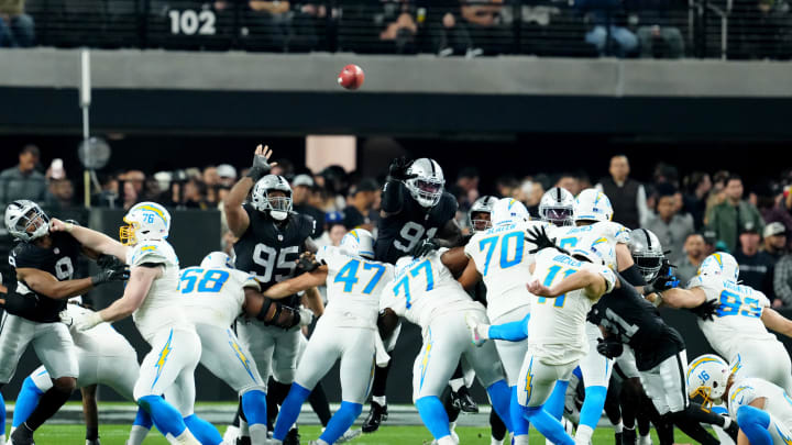 Dec 14, 2023; Paradise, Nevada, USA;  Los Angeles Chargers place kicker Cameron Dicker (11) kicks a field goal against the Las Vegas Raiders in the third quarter at Allegiant Stadium. Mandatory Credit: Stephen R. Sylvanie-USA TODAY Sports