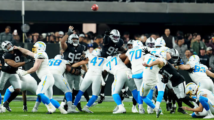 Dec 14, 2023; Paradise, Nevada, USA;  Los Angeles Chargers place kicker Cameron Dicker (11) kicks a field goal against the Las Vegas Raiders in the third quarter at Allegiant Stadium. Mandatory Credit: Stephen R. Sylvanie-Imagn Images