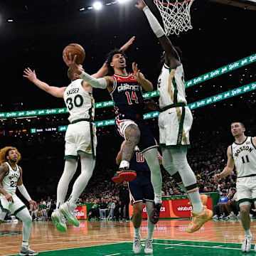 Apr 14, 2024; Boston, Massachusetts, USA;  Washington Wizards guard Jules Bernard (14) drives to the basket between Boston Celtics forward Sam Hauser (30) and center Neemias Queta (88) during the first half at TD Garden. Mandatory Credit: Bob DeChiara-Imagn Images