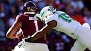 Marshall Thundering Herd defensive lineman Mike Green sacks Virginia Tech Hokies quarterback Kyron Drones.