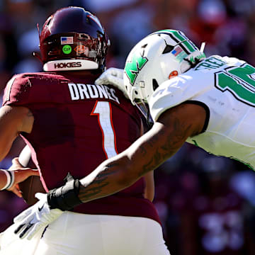 Marshall Thundering Herd defensive lineman Mike Green sacks Virginia Tech Hokies quarterback Kyron Drones.