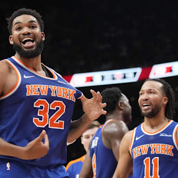 Dec 9, 2024; Toronto, Ontario, CAN; New York  Knicks guard Jalen Brunson (11) watches as center Karl-Anthony Towns (32) celebrates after making a three point basket to clinch a win against the Toronto Raptors near the end of the fourth quarter at Scotiabank Arena. Mandatory Credit: John E. Sokolowski-Imagn Images