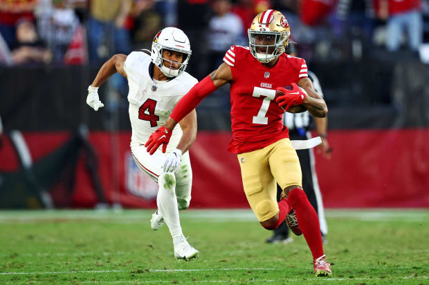 San Francisco 49ers defensive back Charvarius Ward runs with the football after making an interception against the Cardinals.